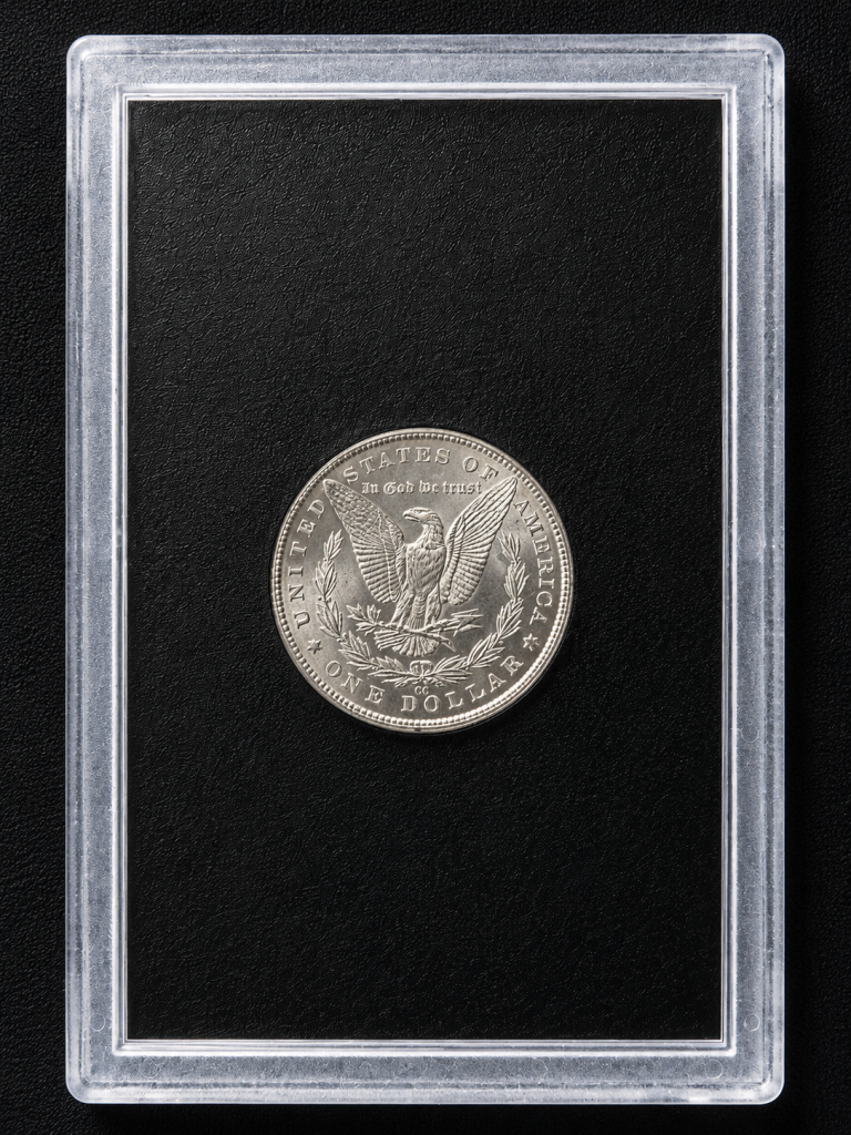 Reverse of an 1883 Carson City Morgan Silver Dollar featuring the heraldic eagle with CC mint mark above the DO in DOLLAR.