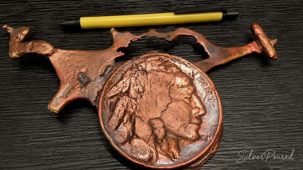 Shop Copper hand-poured Buffalo Nickel copper pour with copper runs extending from the mold during the artisan casting process.