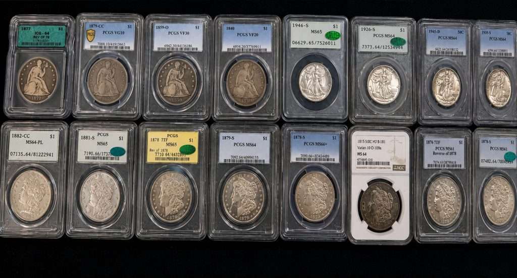 Certified PCGS NGC ANACS and ICG U.S. coins displayed at a coin show