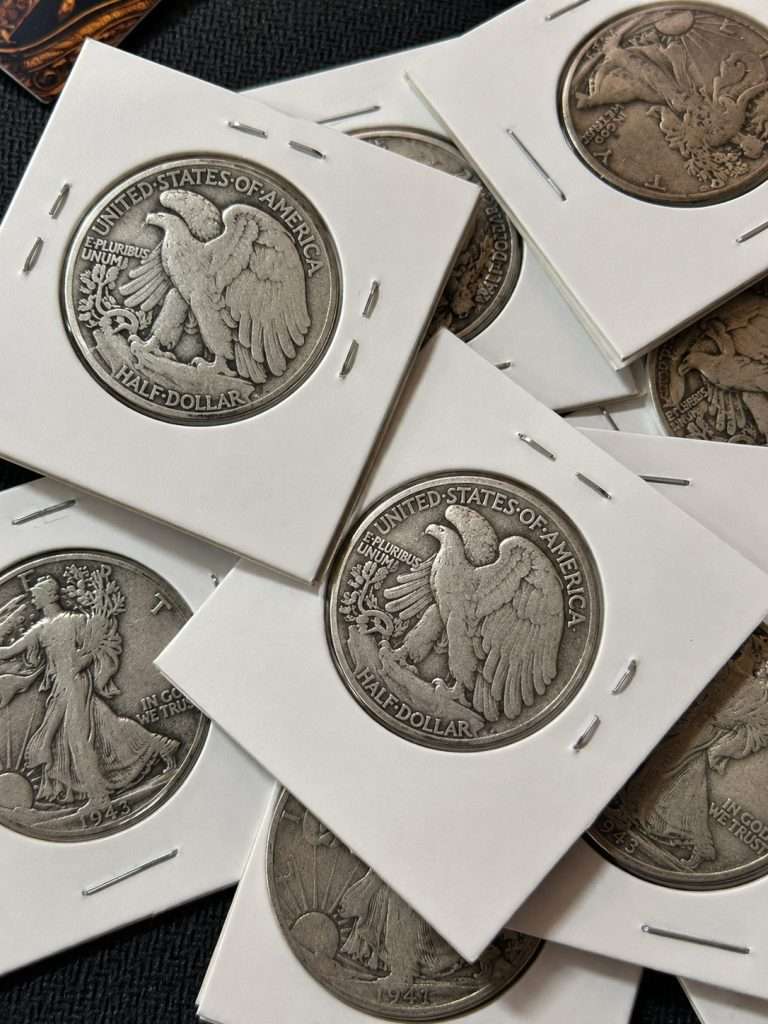 Reverse close-up of a Walking Liberty half dollar silver coin lot featuring historic 90% silver U.S. half dollars in protective cardboard holders